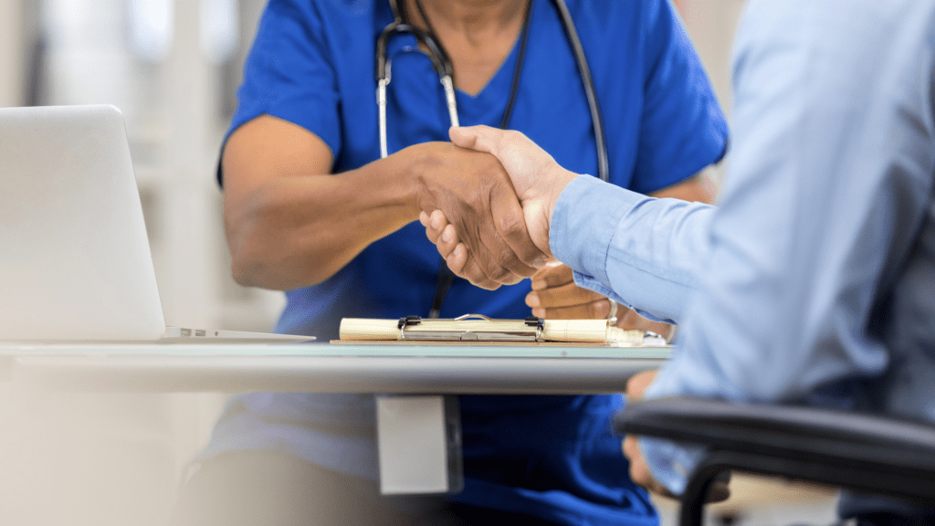 A handshake between a healthcare provider and an IT outsourcing partner.