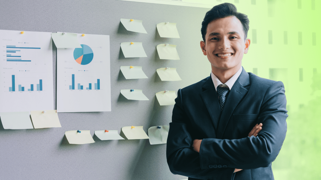 A project manager standing confidently next to project charts, overseeing web development outsourcing.