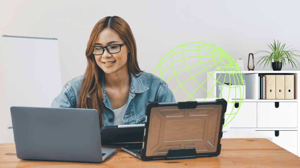 A remote developer working on a web project using a laptop and tablet.